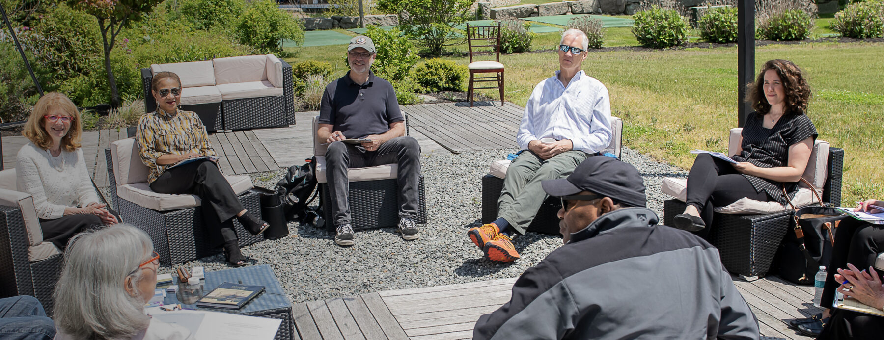 A group of people sit outside having a discussion